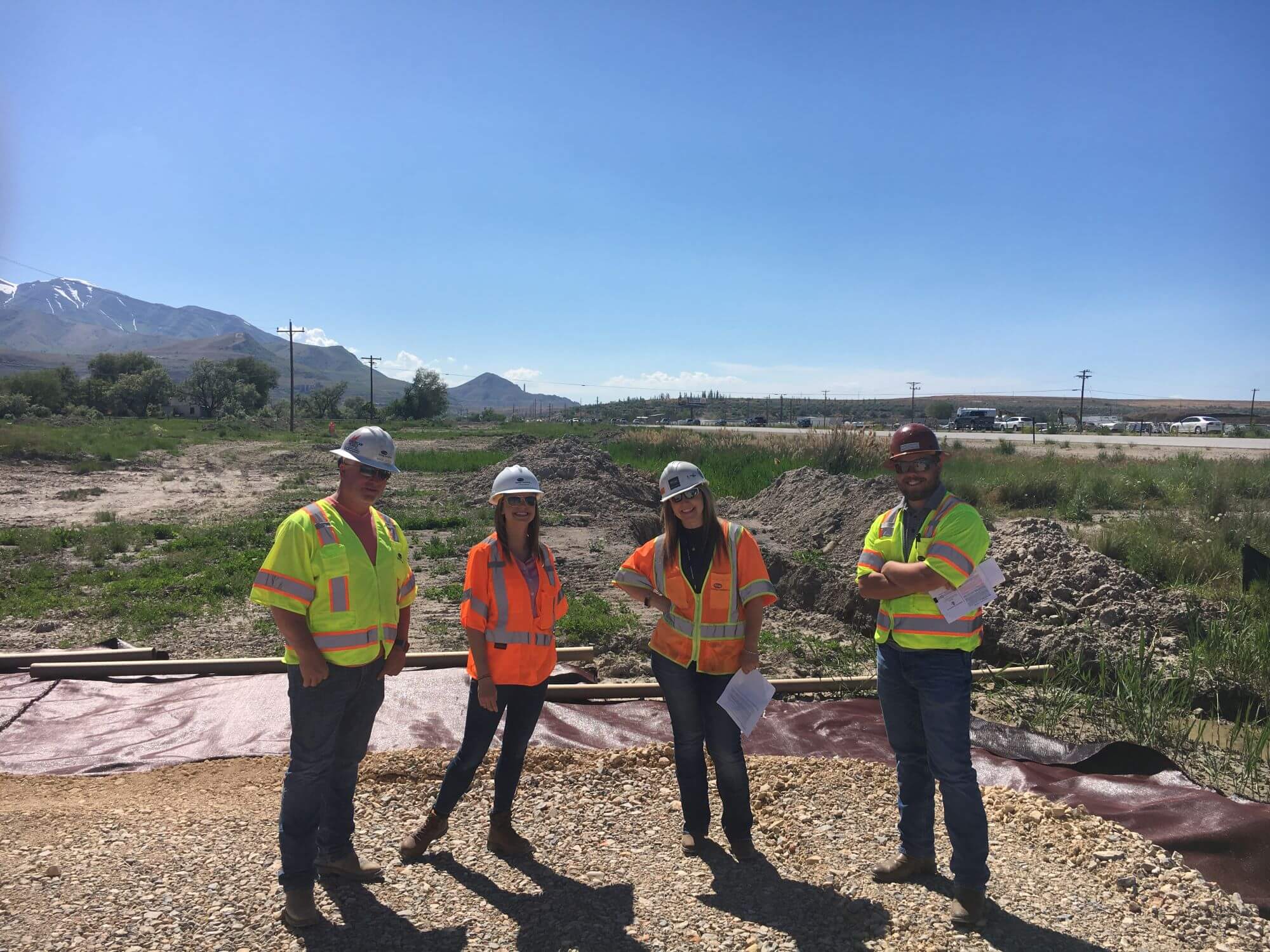 Stanley Consultants employees wearing safety vests and standing at a job site