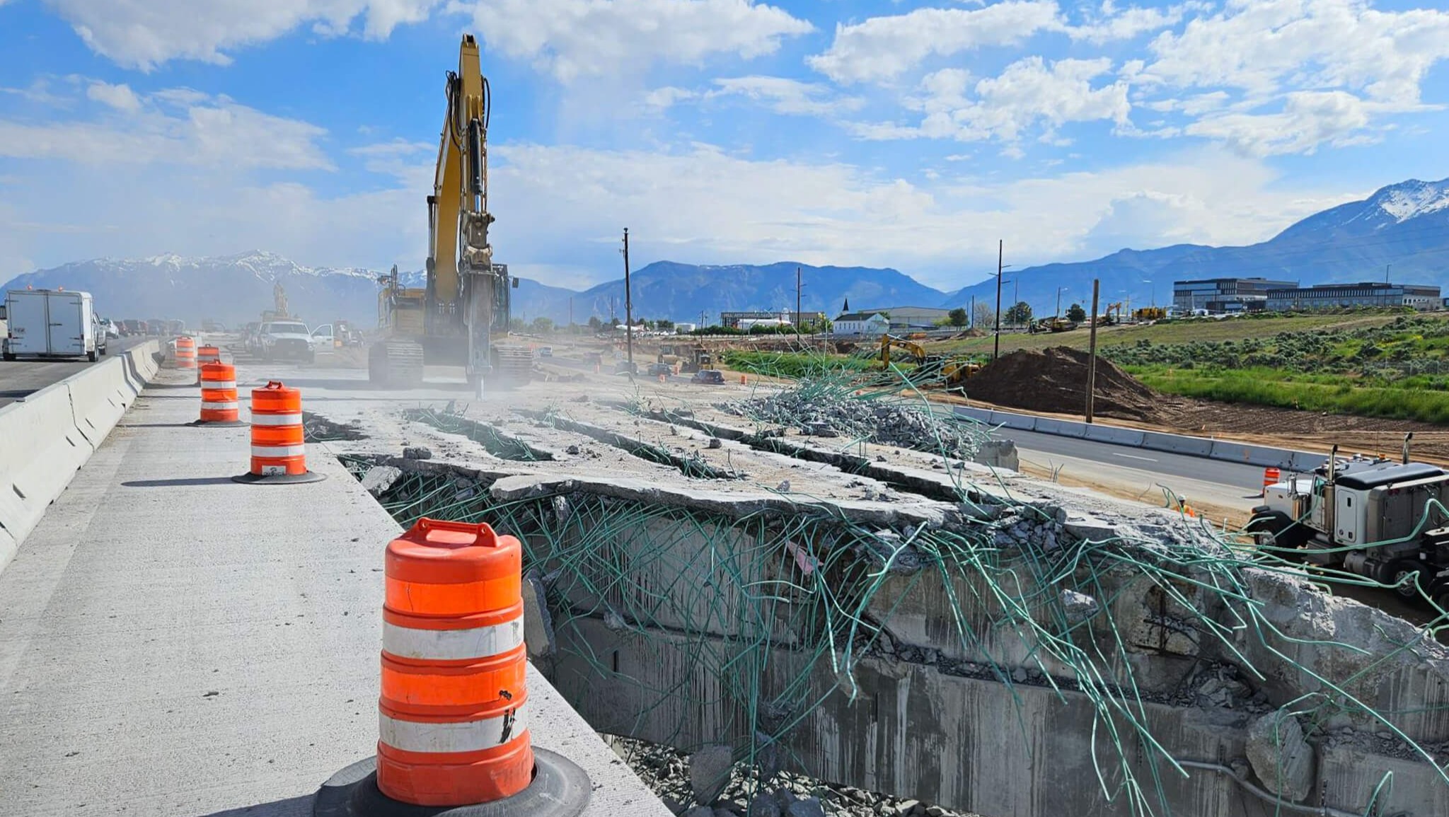 A section of a highway being demolished in a mountainous region
