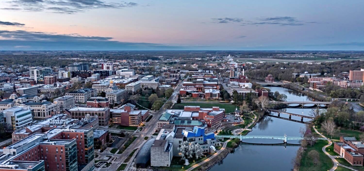 Aeriel perspective of Iowa City and the Iowa River at sunrise